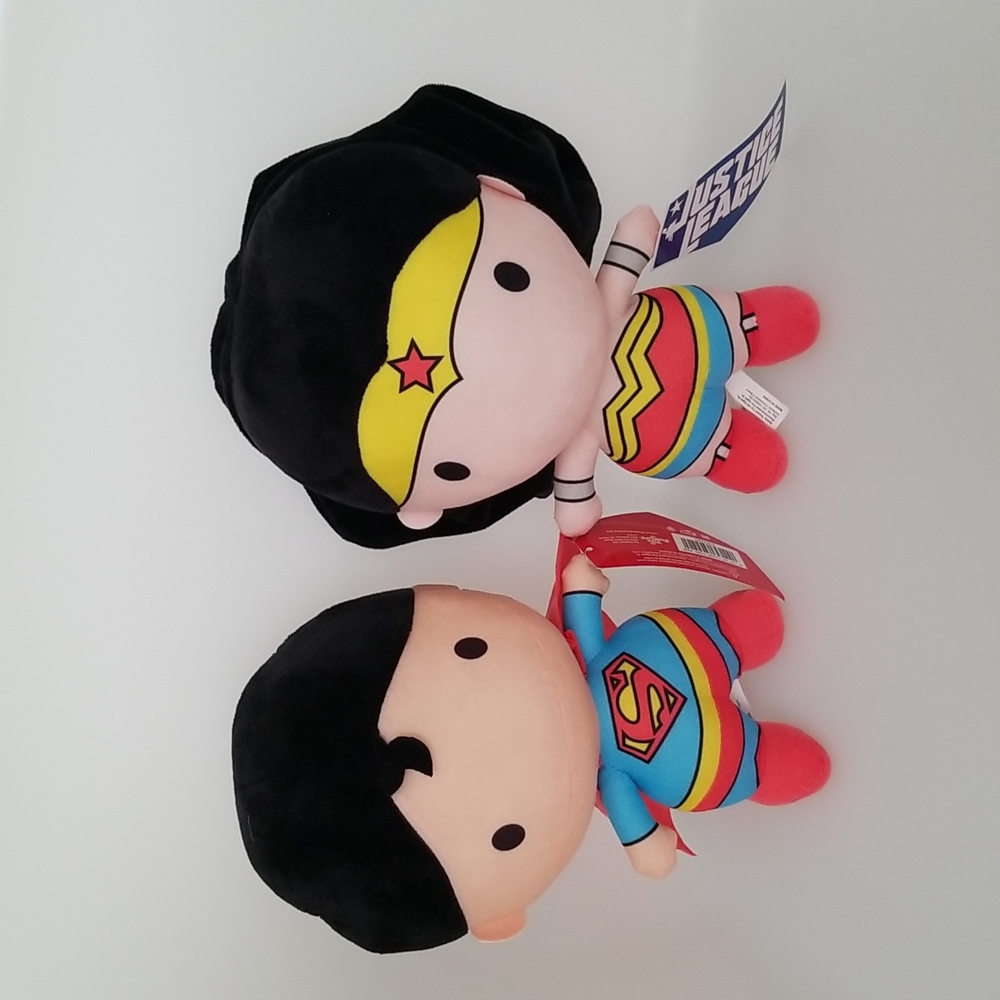 A bundle of Super Man and Wonder Woman Plushies